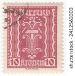 Small photo of AUSTRIA — 1922: 10 krone claret postage stamp depicting Hammer and Tongs as Labor and Industry symbols. The issue shows the symbols of Agriculture, Labor and Industry