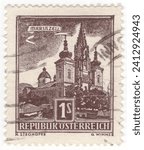 Small photo of AUSTRIA - 1959: 1 shilling chocolate postage stamp depicting Mariazell, city in the southeastern state of Styria. Well known for being a hub of winter sports and a pilgrimage destination