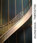 Golden bronze Spiral Staircase Stripes Against a Wall at Orpheum Theatre in Phoenix Arizona 