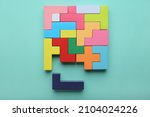 Small photo of Concept of creative, logical thinking. Different colorful shapes wooden blocks on light background. Geometric shapes in different colors. Child development. Riddle and its solution. Logic tasks.
