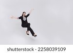 Small photo of Young beautiful smiling asian businesswoman floating in mid-air and announcement something isolated on white background.