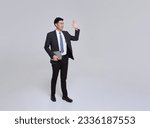 Small photo of Full length young Asian businessman smiling confident walking going waving hand say hello greeting isolated on studio white background.