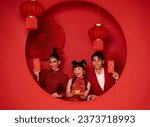 Happy Chinese new year. Asian family holding angpao or red packet monetary gift with text means great luck isolated on red decoration traditional festival background.