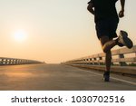 Man running jogging on bridge road. Health activities, Exercise by runner.
