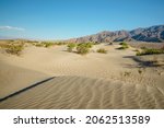 Sand Dunes And Mountains In...