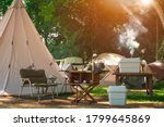 Outdoor Kitchen Equipment and wooden Table set with Field Tents group in Camping area at Natural Parkland