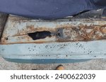 Small photo of Welding a car or van inner fender. Repairing rust holes with a welding machine, welding job. Removing old rusty metal from the fender. Step one.