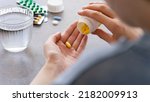 Small photo of Close up woman holding pill in hand with water. Female going to take tablet from headache, painkiller, medication drinking clear water from glass. Healthcare, medicine, treatment, therapy concept