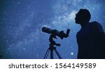 Small photo of Astronomer with a telescope watching at the stars and Moon. My astronomy work.