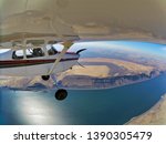 Cessna 175 tail wheel airplane flying over the Columbia River in North Eastern Oregon. Two pilots on board. Camera mounted on wing points back toward front of plane. River & high desert in backgground