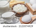 Small photo of Food is a source of calcium, magnesium, protein, fats, carbohydrates, balanced diet. Dairy products on the table: cottage cheese, sour cream, milk, cheese, chicken egg, contain casein, albumin