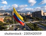 Small photo of Photo of the Colombian flag on a pole with avenue and city buildings in the background. Bogota. Colombia. May 5, 2023.