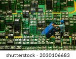 Small photo of Seen from above an air filter factory worker among product component parts is preparing the necessary materials from the filter assembly department, Jakarta-Indonesia.May 31 2017
