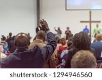 African American Man at Church with His Hand Raised