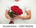 man holding bouquet of red roses, valentines day concept