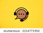 Headphone logo with speech bubble message icon on round wooden for support and customer service concept.