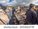 Small photo of Bric a brac stall and stop and go signs at Frome Independent Sunday Market, Somerset, UK on 3 March 2024
