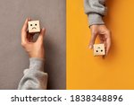 Wooden cubes with the image of a sad and cheerful face. Choosing positive or negative thinking in life