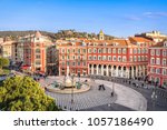 Aerial view of Place Massena square with red buildings  and fountain in Nice, France