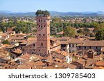 Small photo of Lucca, Italy. Torre Guinigi - brick tower from 14th century topped by holm-oak trees