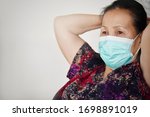 Small photo of The blurry image Old people wearing a mask to protect oneself in the house Avoid gatherings infected with viruses in public.Reduce the loss of life in the elderly And corona protection against viruses