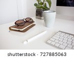 Glasses, notebook and pencil on the desk