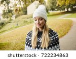 Small photo of Beautiful blond woman in park, looking disown
