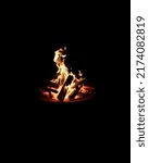 Small photo of A bonfire on a pyre under the black background. Minimalism Bonfire isolated.