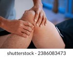 Small photo of physical therapist massaging injured leg of a male athlete. sports injury physical therapy treatment.