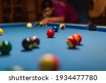 Male ball play snooker billiard player with cue aiming at the table