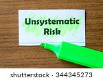 Small photo of unsystematic risk word highlighted on the white paper