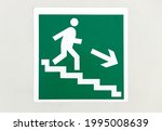 A signpost where to go. A man stepping down the stairs. Information wall sign.