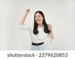 Small photo of Photo of enthusiastic asian young woman rejoicing, say yes, looking happy and celebrating victory, champion dance, fist pump gesture, standing over white background