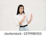 Small photo of People emotions concept. Reluctant and disgusted asian woman tell to stay away from her, step back and raising hands up defensive, grimacing from aversion and dislike