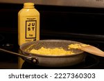 Small photo of Portland, OR, USA - Nov 4, 2021: Scrambled eggs made with JUST Egg plant-based scramble in a pan on an electric stove. Eat Just Inc. develops vegan alternatives to conventionally produced egg products