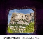 Mount Rushmore National Memorial though the Doane Robinson Tunnel on Iron MountaIn Road part of the Peter Norbeck Scenic National Byway in the Black Hills of South Dakota USA