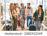 Group of university college tourist walking inside the hotel with suitcases -Young happy students enjoying summer holiday-Tourism Vacation and Lifestyle concept with people-Youth culture-Spring time