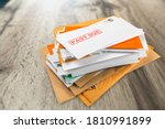 Small photo of Pile of envelopes with overdue utility bills on the desk