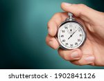 Silver classic stopwatch in human hand