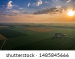 Hazy Rural Sunrise - an aerial view via drone of the sunrise over the farm in northwest Ohio with clouds and mist in the horizon.