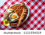 Small photo of Bandeja paisa, typical dish at the Antioquia region of Colombia. It consists of chicharron (fried pork belly), black pudding, sausage, arepa, beans, fried plantain, avocado egg, and rice.
