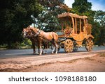 A horse drawn carriage in front of an yellow taxi in Kolkata India