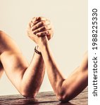 Small photo of Two man's hands clasped arm wrestling, strong and weak, unequal match. Arm wrestling. Heavily muscled bearded man arm wrestling a puny weak man.