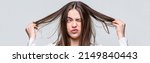 Small photo of Bad hairs day. Frustrated woman having a bad hair. Woman having a bad hair, her hair is messy and tangled. Messy hair. Brunette woman with messed hairs. Girl having a bad hairs.