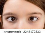 Small photo of Strabismus. Close-up part child's face, eyes girl. Little patient strabismus, treatment ophthalmic diseases. Strabismus in children causes, treatment concept. Female eyes with strabismus. Hypertropia.