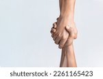 Small photo of Friendly handshake, friends greeting, teamwork, friendship. Close-up. Rescue, helping gesture or hands. Strong hold. Two hands, helping hand of a friend. Handshake, arms friendship