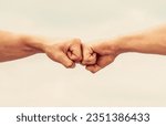 Small photo of Teamwork and friendship. Partnership concept. Man giving fist bump. Bumping fists together. Fist Bump. Clash of two fists. Concept of confrontation, competition.