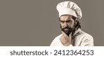 Small photo of Bearded chef, cooks or baker. Bearded male chefs. Cook hat. Confident bearded male chef in black uniform. Serious cook in white uniform, chef hat. Portrait of a serious chef cook.