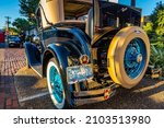 Small photo of Fernandina Beach, FL - October 18, 2014: Wide Angle low perspective rear corner detail view of a 1931 Ford Model A coupe equipped with a rumble seat at a classic car show in Fernandina Beach, Florida.