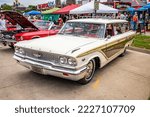Small photo of Des Moines, IA - July 02, 2022: High perspective front corner view of a 1963 Ford Country Squire Station Wagon at a local car show.